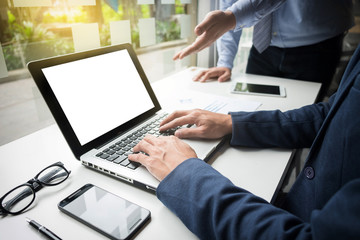 Teamwork process, Businessmen hands pointing at laptop and document during explanation of new plan project data at meeting.