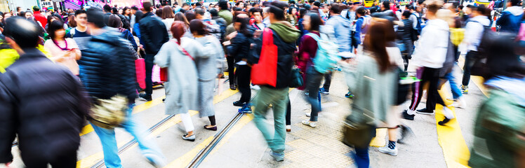 people crossing a street in Hong Kong with motion blur - obrazy, fototapety, plakaty