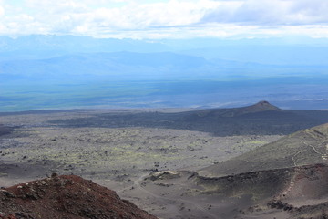Black and red ash, valley of hills, after volcanic eruption