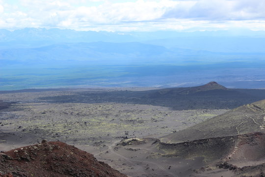 Black and red ash, valley of hills, after volcanic eruption