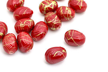 Decorative red beads scattered on white background - accessories for handmade and hobby