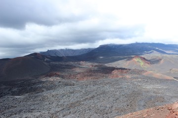 Black and red ash, valley of hills, after volcanic eruption