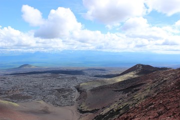 Black and red ash, valley of hills, after volcanic eruption