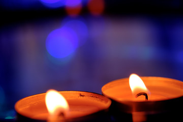 Candle light in the water in the pool on the twilight.