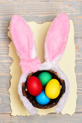 colorful eggs inside bucket and rabbit ears. Happy Easter concept