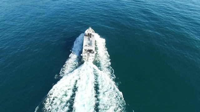 Aerial perpendicular view of a ferry transporting passengers navigating off the coast of Amalfi, Italy.