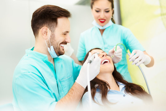 Dentist at work. Young female patient visiting dentist office