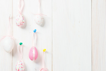 Happy easter eggs decoration on white wooden background.