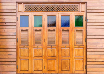 Complex wooden window with the colorful glass.