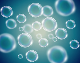 Transparent soap bubbles blue background with defocused elements