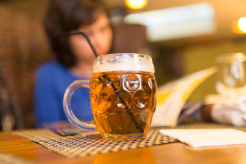 Girl with a mug of beer in a restaurant
