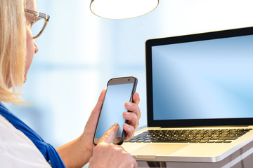 Senior woman typing on blank smart phone.