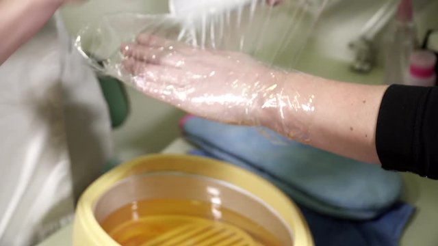 Woman is having a hand paraffin wax treatment