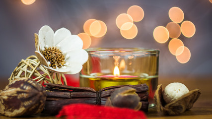 Candle and Potpourri on burlap with light bokeh in background