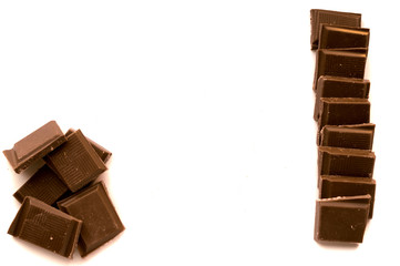 Pieces of chocolate on white background.