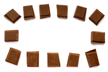 Pieces of chocolate on white background. Raw materials for designers.