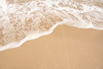 Fototapeta na wymiar Soft wave lapped the sandy beach, Summer Background.