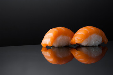 closeup of sushi with rice on grey  background with reflection