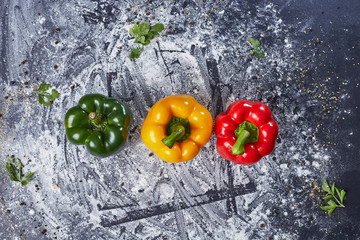 Red green yellow pepper in the kitchen black beautiful background