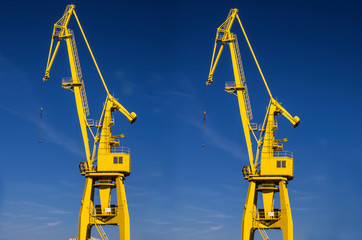 Port crane, yellow, blue sky. © Aneta