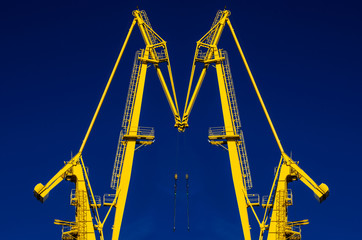 Port crane, yellow, blue sky. © Aneta
