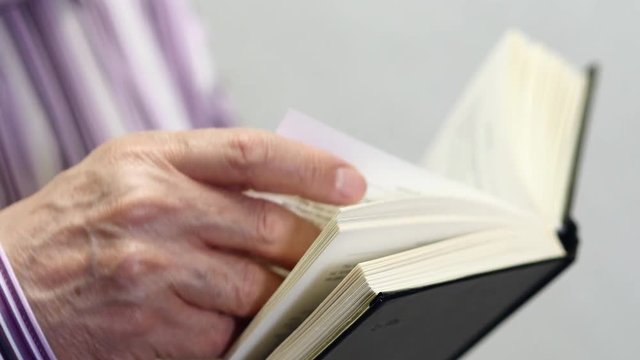 Fingers Leafing Reading A Paper Book
