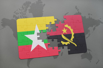 puzzle with the national flag of myanmar and angola on a world map