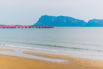 Prachuap Khiri Khan city, Thailand, a capital of the same name province. The main pier, the city beach and view on a distant rock