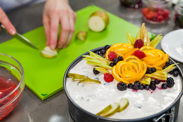 Confectioner decorates fruit cake