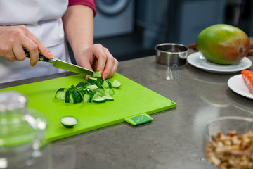 The chef prepares a salad with salmon