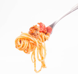 Spaghetti bolognese on a fork on a white background