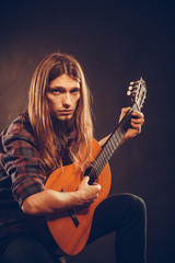 Guitarist is playing the guitar.