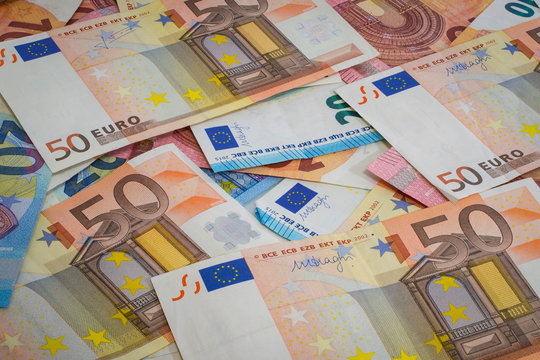 Different euro notes spread on a table