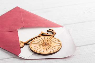 Red envelope with empty paper and wooden bike