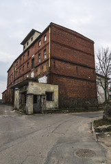 Fototapeta na wymiar Old red brick abandoned warehouse