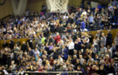 blurred background of crowd of people in a basketball court