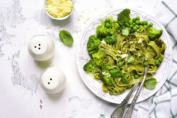 Spring spinach tagliatelle with broccoli and green pea.Top view.