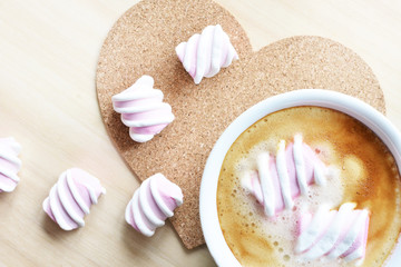 Obraz na płótnie Canvas cup of coffee with pink marshmallow