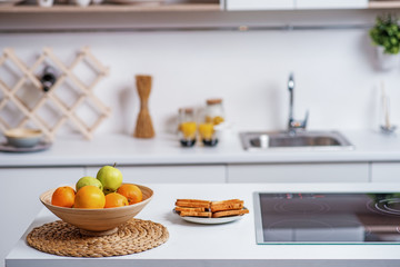 Obraz na płótnie Canvas Healthy fruits in plate near electric stove at home