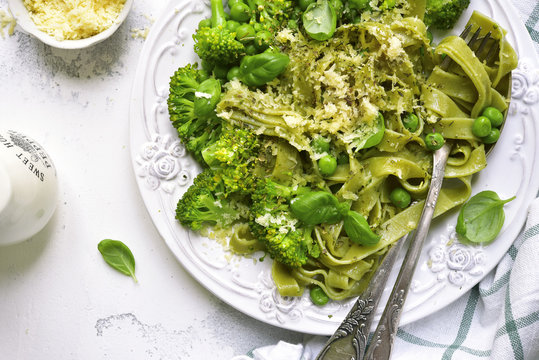 Spring spinach tagliatelle with broccoli and green pea.Top view.
