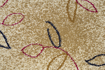 a colorful texture containing a mosaic of interwoven wool fibers containing leaf motifs zoom on full frame