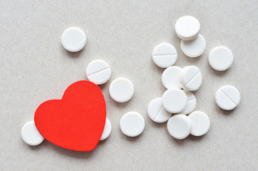 white tablets with red heart