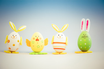 bunny and chicken shaped painted easter eggs