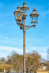 Fototapeta na wymiar Old street lamp made of green metal