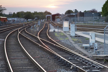 Fototapeta na wymiar Railway Tracks at Dusk in Urban Setting