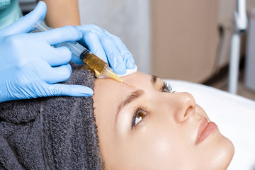 procedure Plasmolifting injection. plasma injection into the skin of the forehead of patient