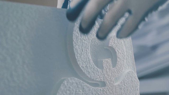 Process of creating volumetric figures of foam plastic. Cutting out volumetric letters of foam plastic. Figured cutting of foam plastic. Creation of a volumetric inscription. Decor of foam plastic.