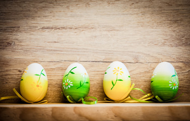 easter card with eggs and pussy willow on rustic wooden background