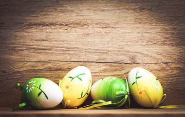 easter card with eggs and pussy willow on rustic wooden background