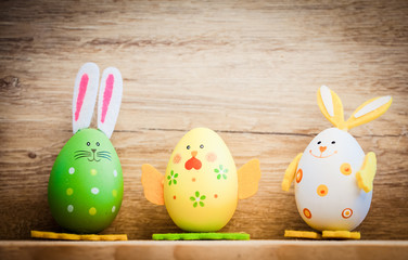 easter card with eggs and pussy willow on rustic wooden background